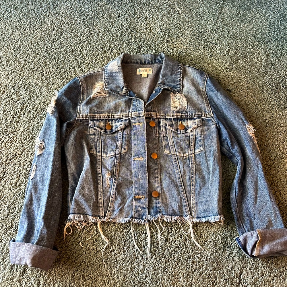 Distressed women’s cut off denim jacket